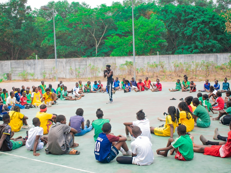 A group of young people gathered together outdoors, representing PWCDC's Youth Development program (stock photo placeholder)